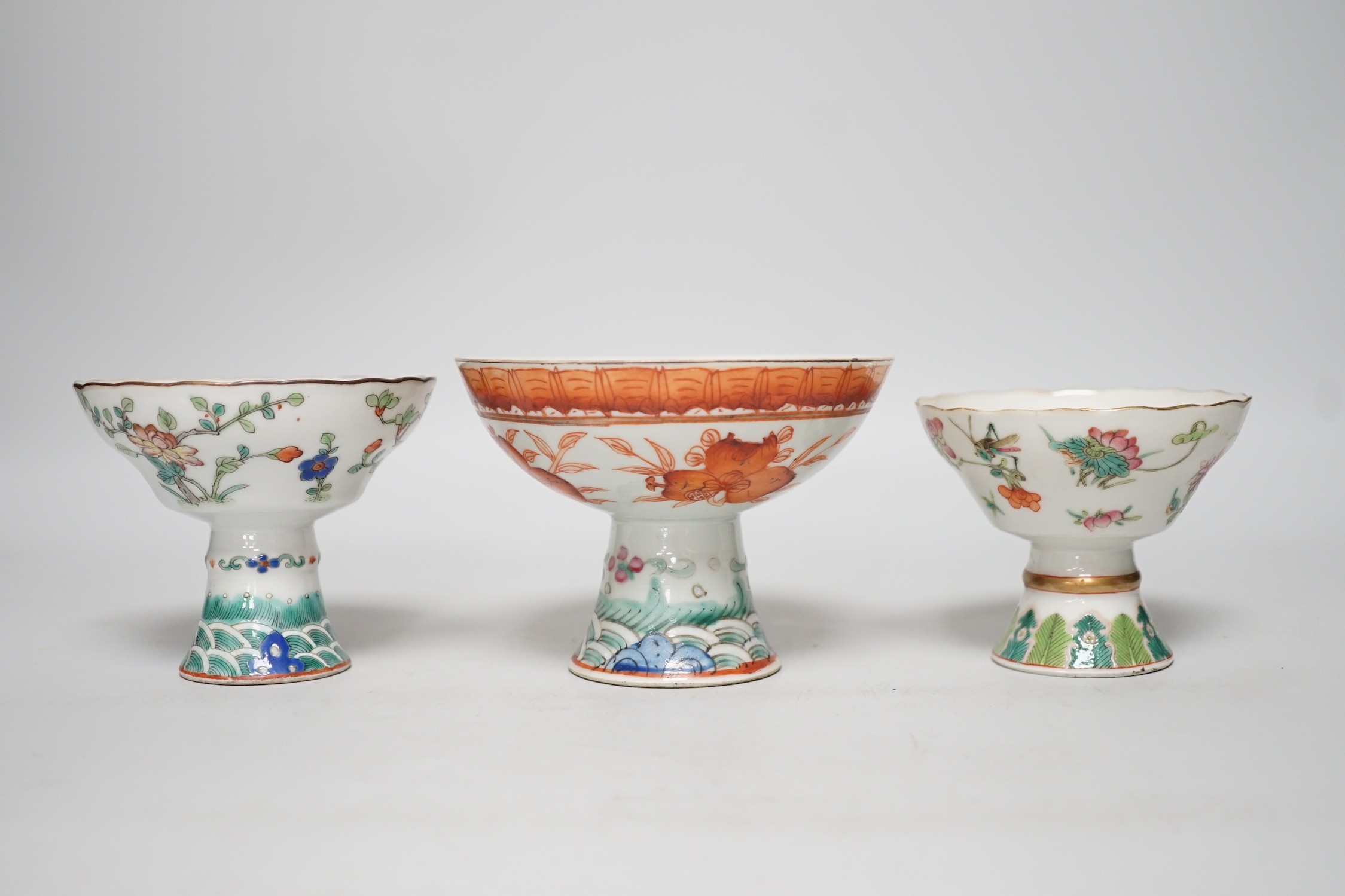 Three 19th century Chinese stem cups, painted with insects, flowers, bats and peaches, largest 9cm